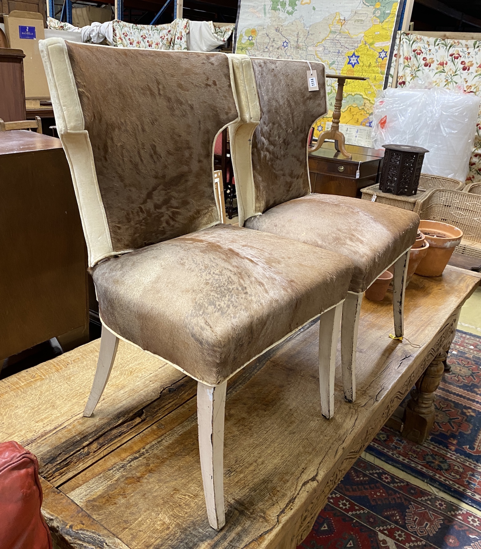 A pair of Regency style hide covered side chairs, width 56cm, depth 43cm, height 92cm